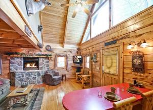 a living room with a table and a fireplace at Sticks and Stones in Sevierville