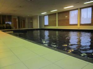 an empty swimming pool in a building with water at Hotel De Watermolen in Bocholt