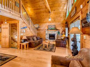 a living room with a fireplace in a log cabin at License To Chill in Pigeon Forge