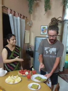a man and a woman standing in front of a table with food at ALPANEST - Near GMCH and B Barooah Cancer in Guwahati