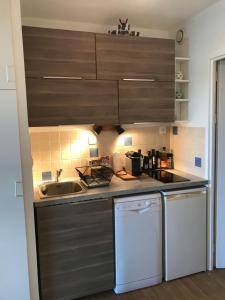 a small kitchen with a sink and a dishwasher at Maison Loubière in Hyères