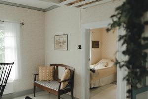 a room with a bed and a chair and a bedroom at Lillstugan in Vöyri