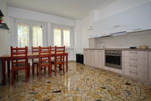 a kitchen with a table and chairs and a stove at CLESIO 2 in Trento