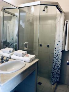 a bathroom with a sink and a shower at Hotel Azul by MH in Punta del Este