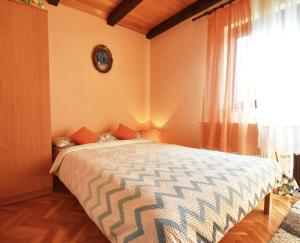 a bedroom with a bed with a clock on the wall at Holiday Home Lana in Fužine