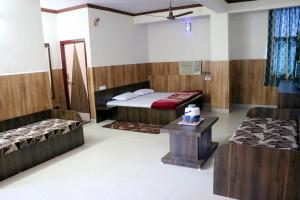 A bed or beds in a room at Jain Residency