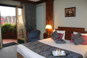 Postel nebo postele na pokoji v ubytování Hotel Le Mandelberg