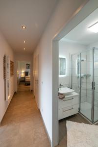 a bathroom with a glass shower and a sink at Ferienwohnung Jäger Veronika in Altenmarkt im Pongau