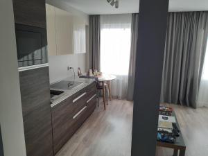 a kitchen with a sink and a counter with a table at Atbrīvošanas aleja 80 in Rēzekne