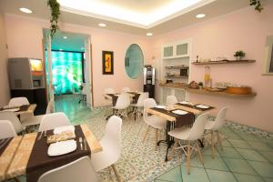 a restaurant with tables and chairs in a room at Hotel Potenza in Naples