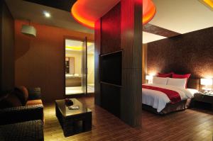 a hotel room with a bed and a television at One + One Motel in Longtan