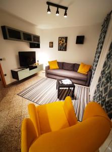 a living room with a couch and a tv at Apartment Dora in Rijeka