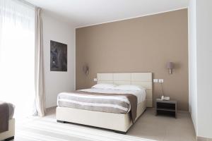 Voodi või voodid majutusasutuse Moma Hotel Wellness & Spa toas