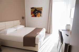 Voodi või voodid majutusasutuse Moma Hotel Wellness & Spa toas