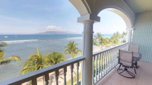 a balcony overlooking a beach with a view of the ocean at Lahaina Shores Beach Resort, a Destination by Hyatt Residence in Lahaina