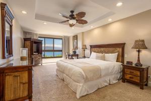 a bedroom with a large bed and a large window at Kaanapali Alii, a Destination by Hyatt Residence in Lahaina