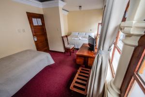 Postel nebo postele na pokoji v ubytování Hostal El Peregrino