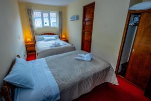 Postel nebo postele na pokoji v ubytování Hostal El Peregrino