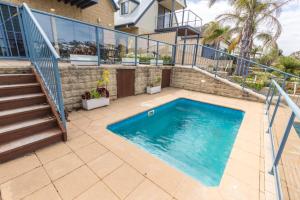 a swimming pool in the backyard of a house with a staircase at The Loft in Paynesville