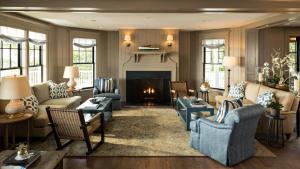 a living room with furniture and a fireplace at Harbor View Hotel in Edgartown