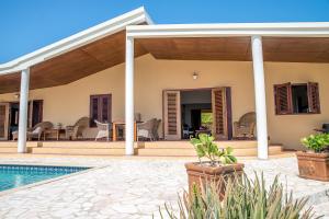 a villa with a swimming pool and a house at Pelican Villa in Lagun