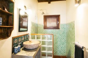 a bathroom with a sink and a glass shower at Pelican Villa in Lagun