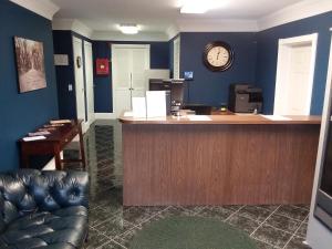 an office with a counter with a clock on the wall at Walton Inn in Willard