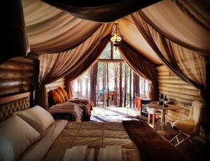 a bedroom with two beds and a large window at Tedesco Eco Park in São Francisco de Paula