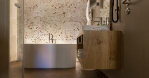 a bathroom with a large tub and a sink at Romantik Hotel Markusturm in Rothenburg ob der Tauber