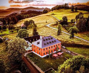 an aerial view of a large orange building on a hill at Wellness Hotel Zámeček in Jetřichovice