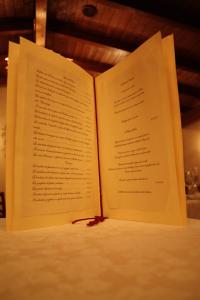 an open book sitting on top of a table at Il Poeta Contadino Country House in Ripa