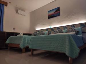 Postel nebo postele na pokoji v ubytování Kai Hotel