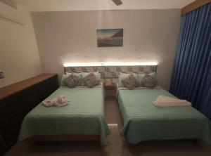 Postel nebo postele na pokoji v ubytování Kai Hotel