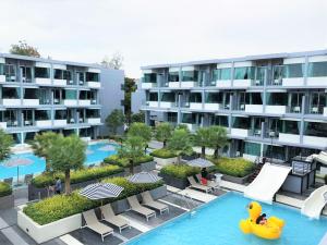 an apartment building with a pool and a rubber duck in the water at Bay Window at Sea in Cha Am