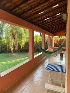 a hammock on the porch of a house at Chácara Santo Antonio in Brotas