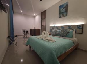 Postel nebo postele na pokoji v ubytování Kai Hotel