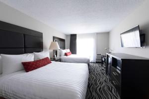 a hotel room with two beds and a television at SureStay Hotel by Best Western Castlegar in Castlegar