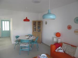 a living room with a table and chairs and a couch at El Balcón de la Luna in Bajamar