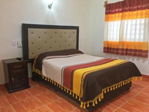 En eller flere senge i et værelse på Casa de huéspedes "Elim"