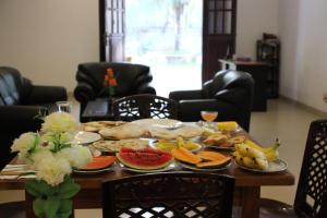 a table with food and fruit on it at Miheen Hotel & Resort - Anuradhapura in Mihintale