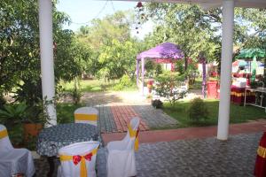 a patio with a table and chairs and a tent at Miheen Hotel & Resort - Anuradhapura in Mihintale