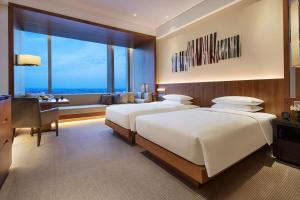 Postel nebo postele na pokoji v ubytování Hyatt Regency Changchun