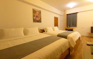 Postel nebo postele na pokoji v ubytování 高寮貳陸之貳民宿 Gaoliao 26-2 Simple Home Life