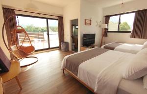 Postel nebo postele na pokoji v ubytování 高寮貳陸之貳民宿 Gaoliao 26-2 Simple Home Life