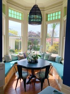 a living room with a couch and a table at The Vicarage Boutique Bed and Breakfast Oamaru in Oamaru