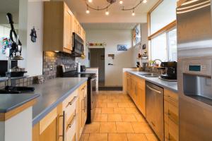 a large kitchen with wooden cabinets and stainless steel appliances at Private Room with Shared Bath in Mountain View