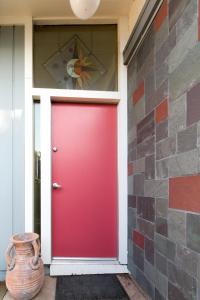 a red door on a house with a brick wall at Private Room with Shared Bath in Mountain View