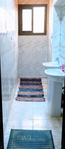 a bathroom with a sink and a toilet and a sink at Pyramids Loft Guesthouse in Cairo