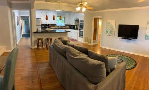 a living room with a couch and a kitchen at The Peacock House in San Antonio