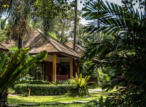 a house in the middle of a forest at Anahata Resort in Lipa Noi